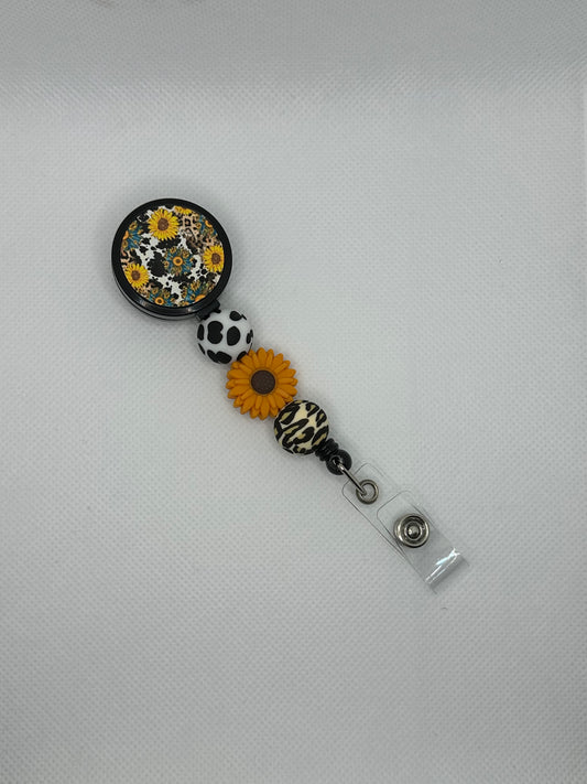 Sunflower And Cow Black Badge Reel